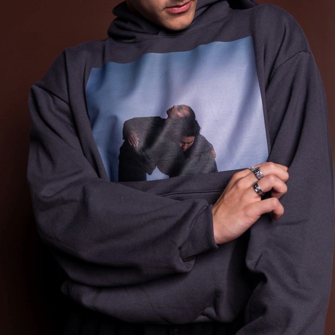 The grey Portrait Hoodie printed with a photo of two embracing dancers