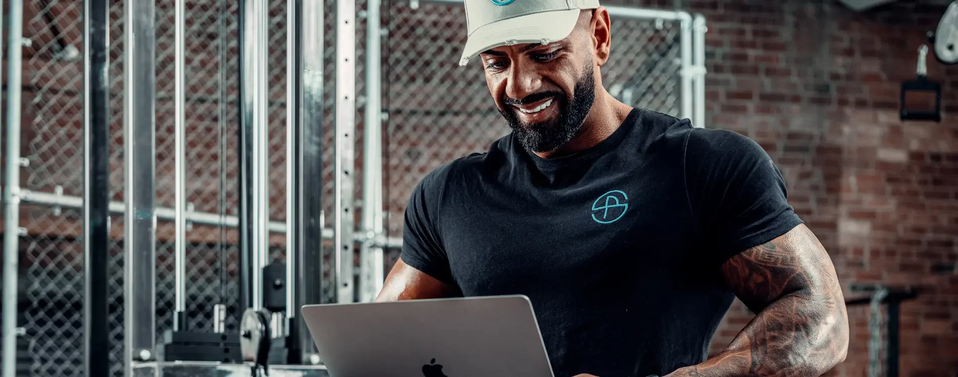 Pav Savva working on an online coaching plan in the gym
