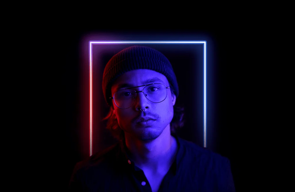 Rokin filmmaker lit by red and blue neon