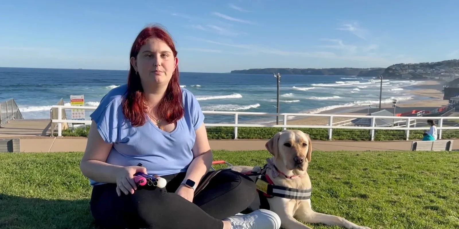 Kirsten Busby and her guide dog Kimba together by the beach