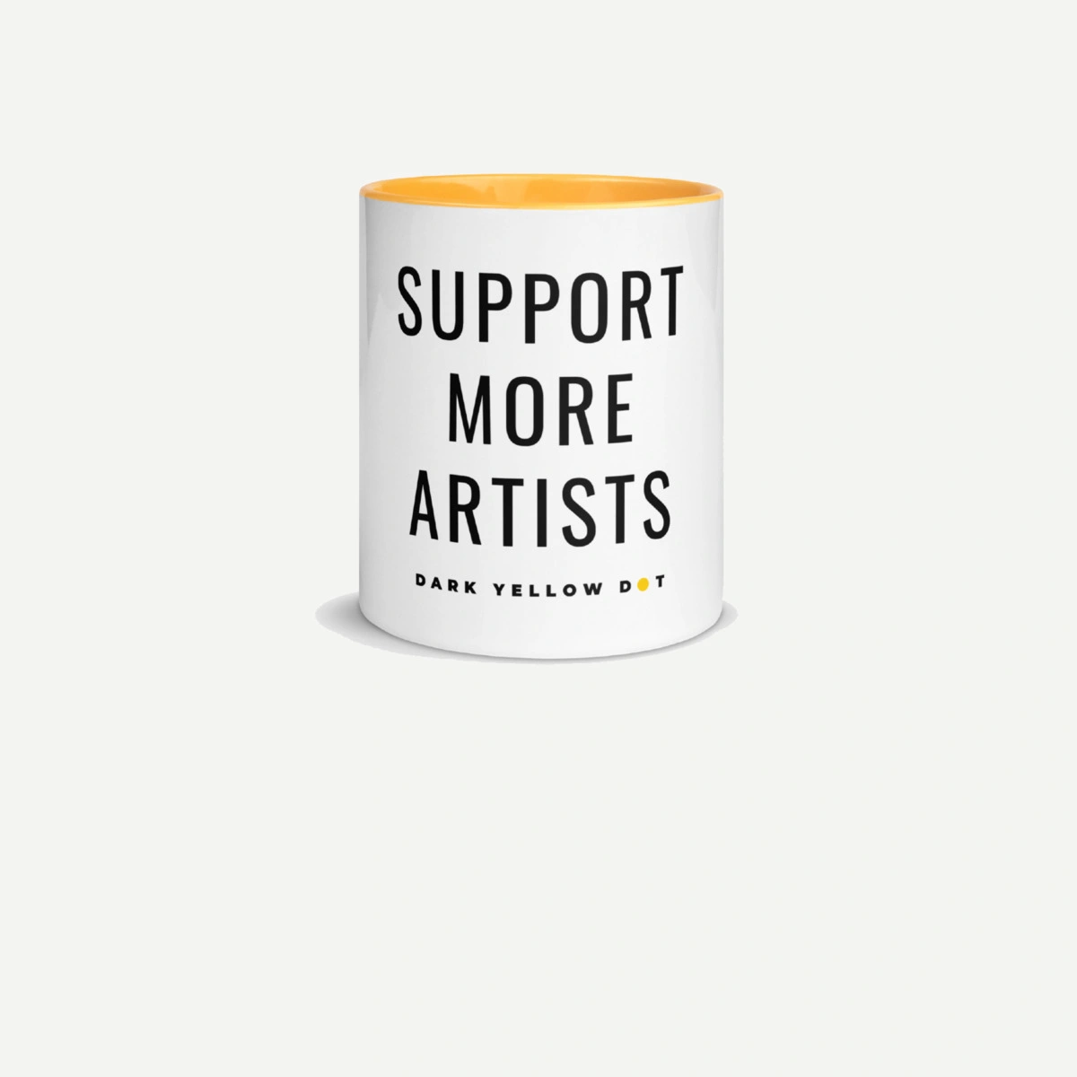 White Support More Artists mug with a yellow inside