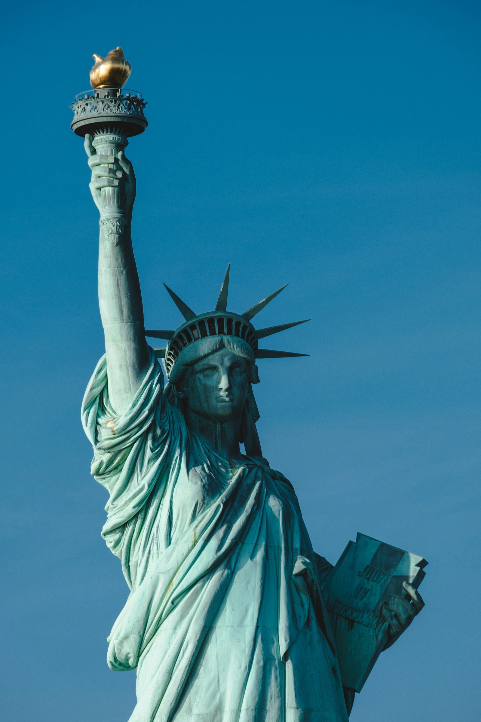 Statue of Liberty against a deep blue sky