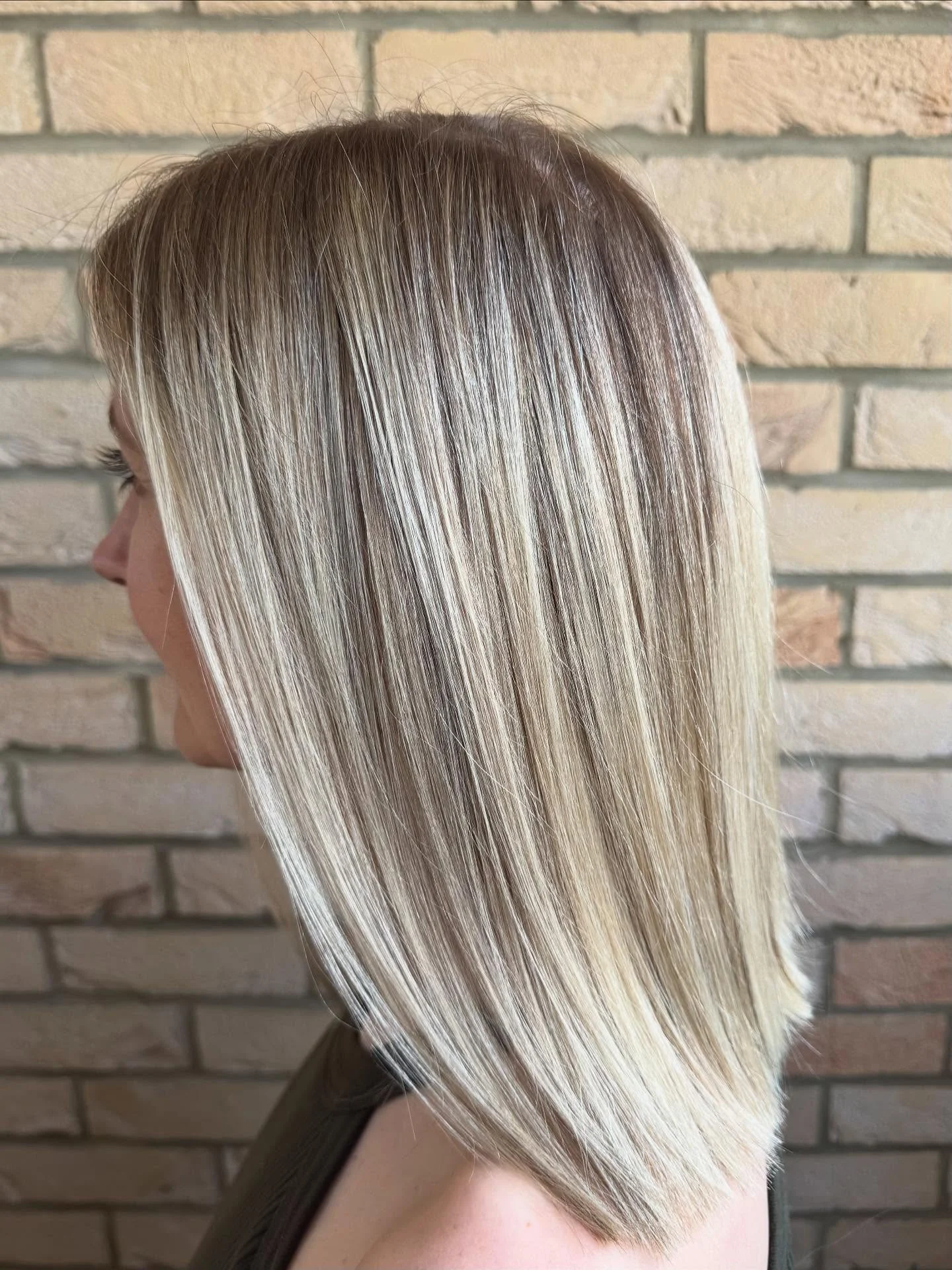 Sleek shoulder-length blonde cut with a bright, dimensional finish