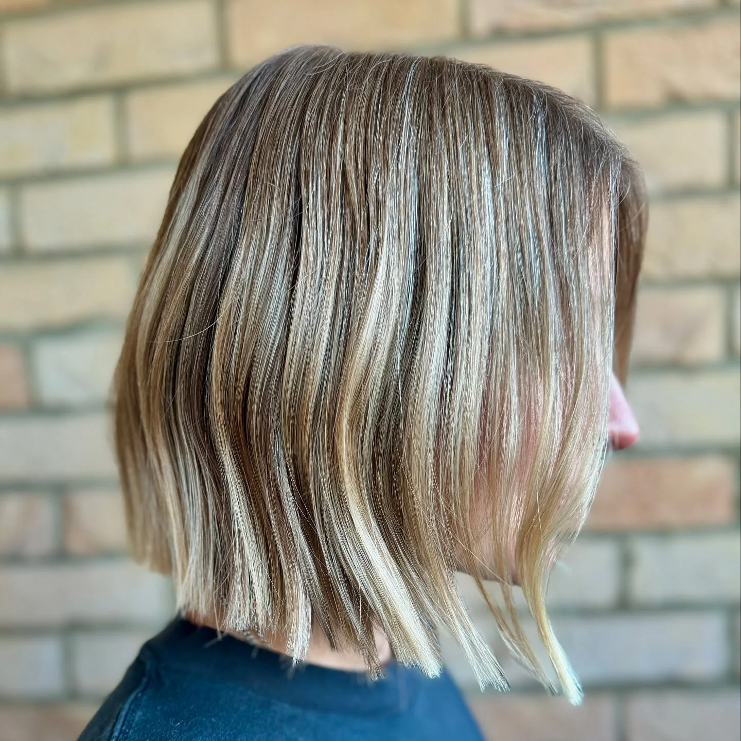 Precision-cut blonde bob with natural depth and bright face-framing pieces