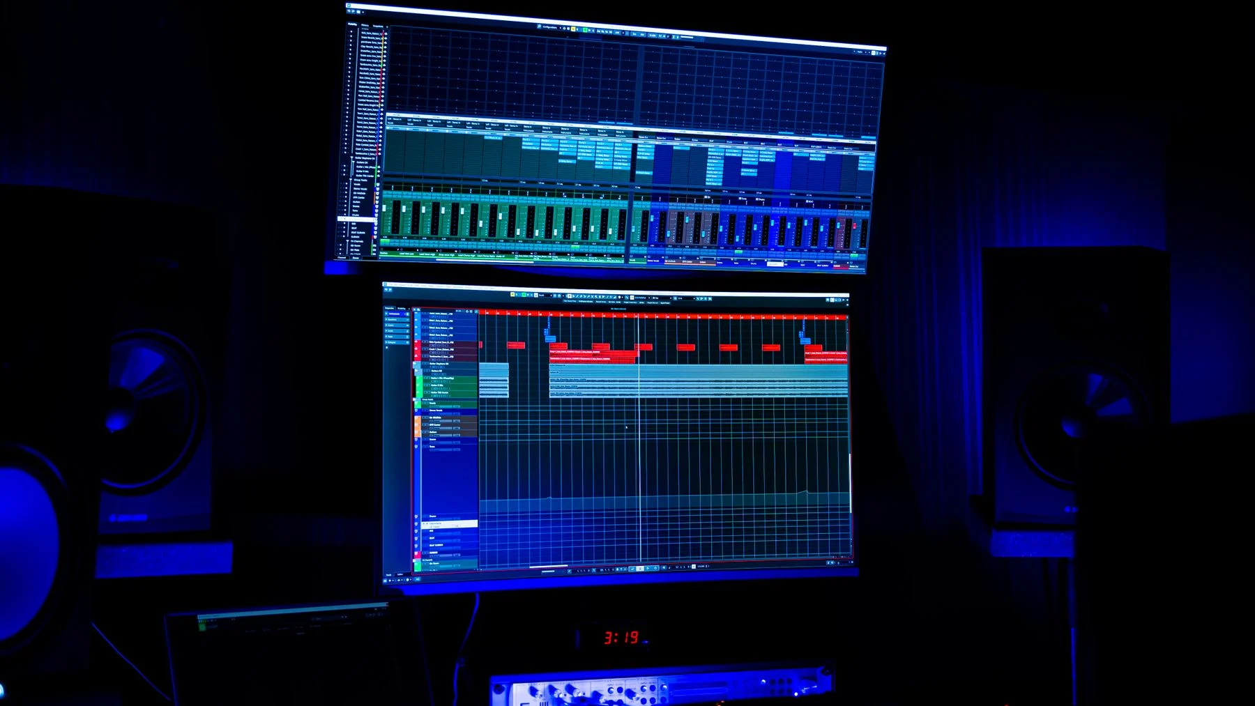 A music production studio illuminated in blue