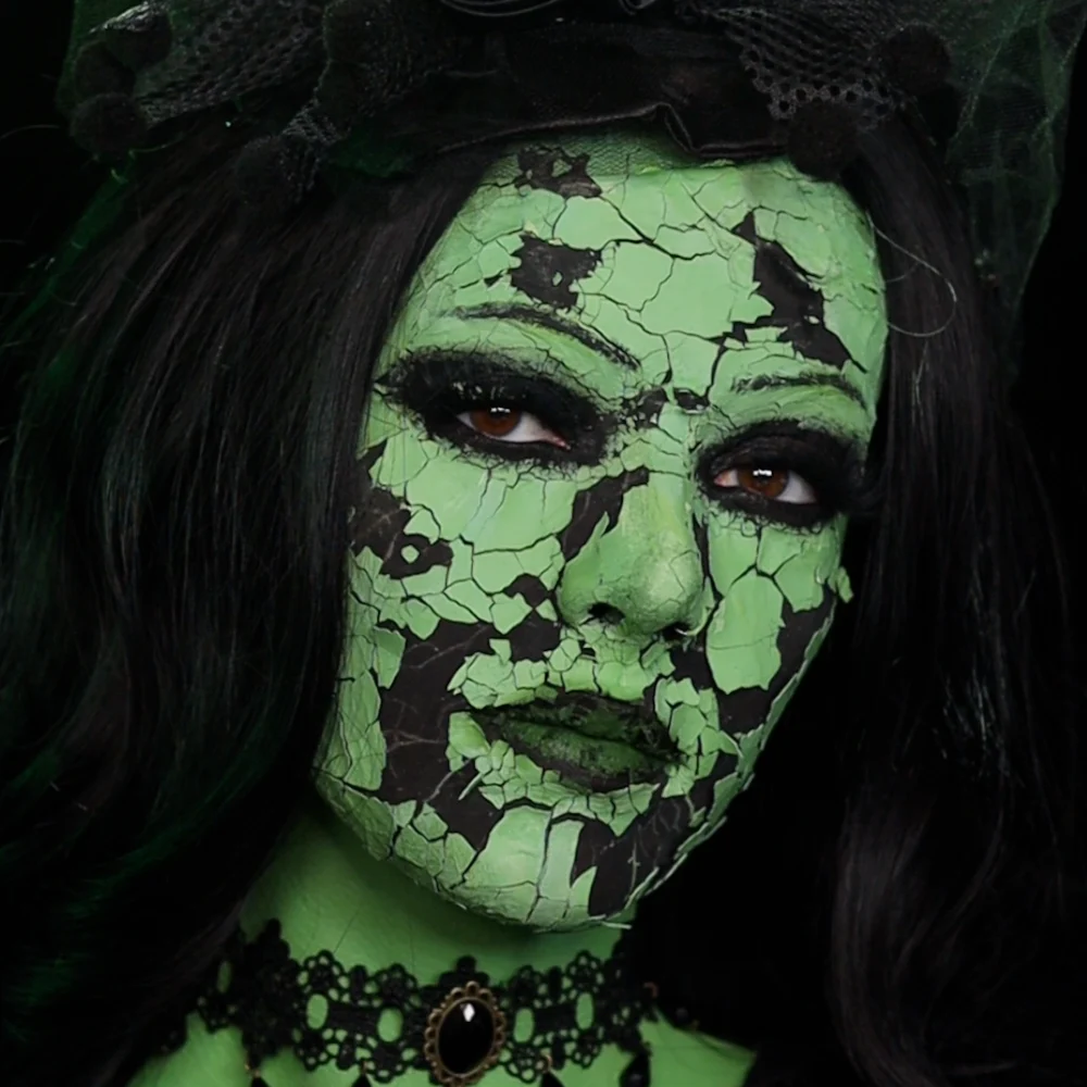 Piper Nelson wearing a cracked green witch makeup transformation