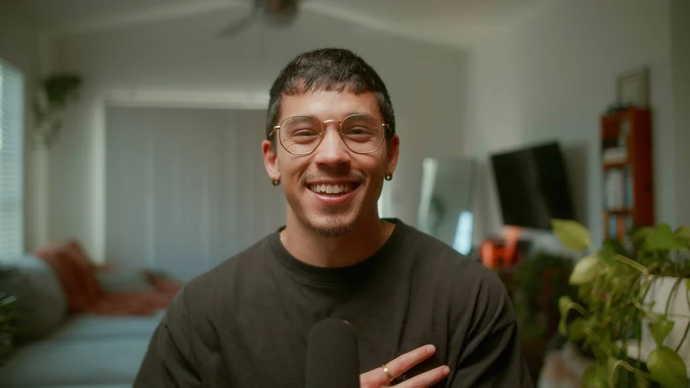 Ashton Taylor smiling during a conversation