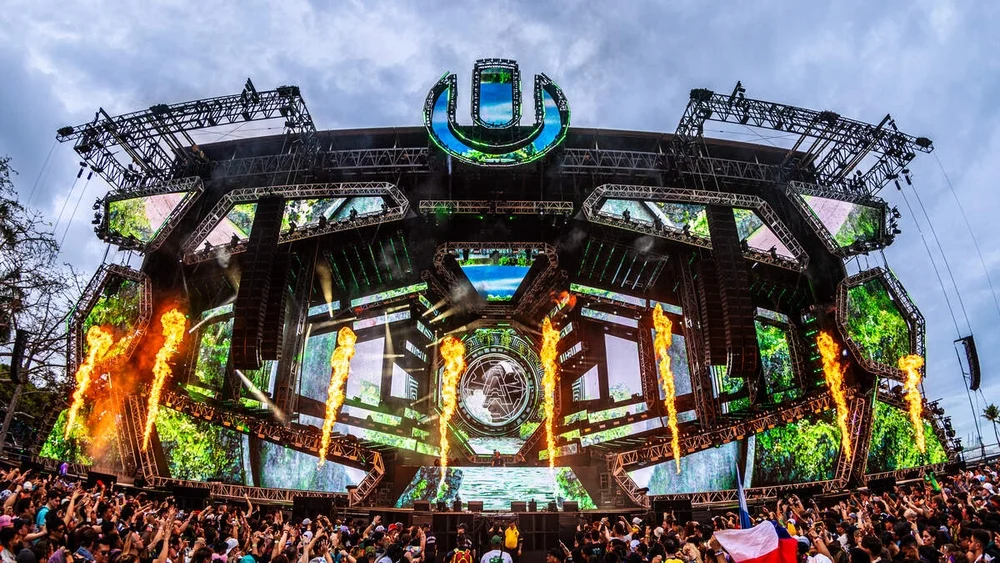 Ultra Music Festival main stage with flames and a daytime crowd