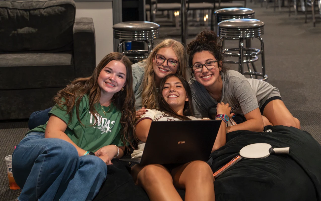 Two42 students smiling together at a ministry gathering