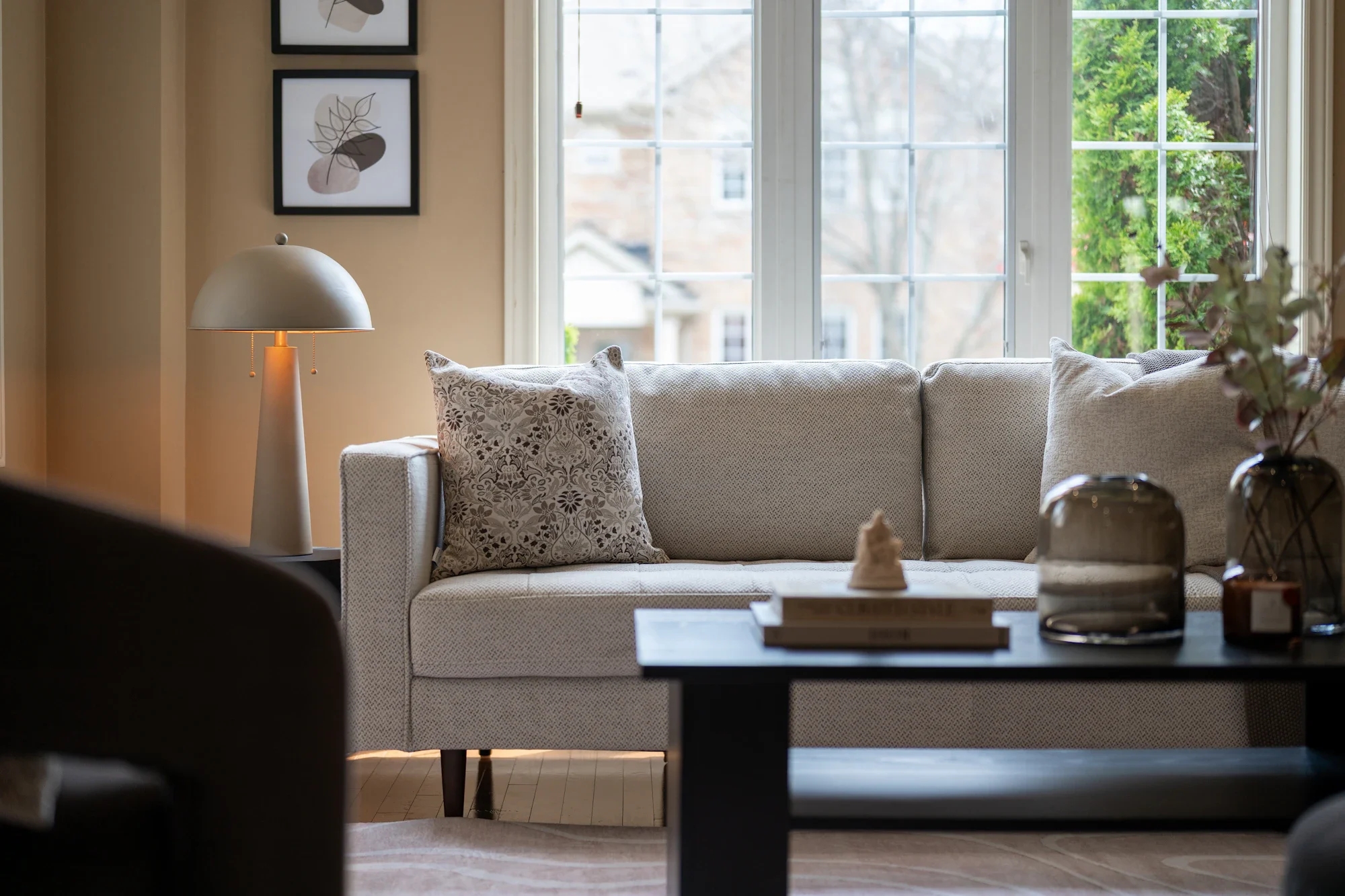 A bright, welcoming living room with warm neutral furnishings
