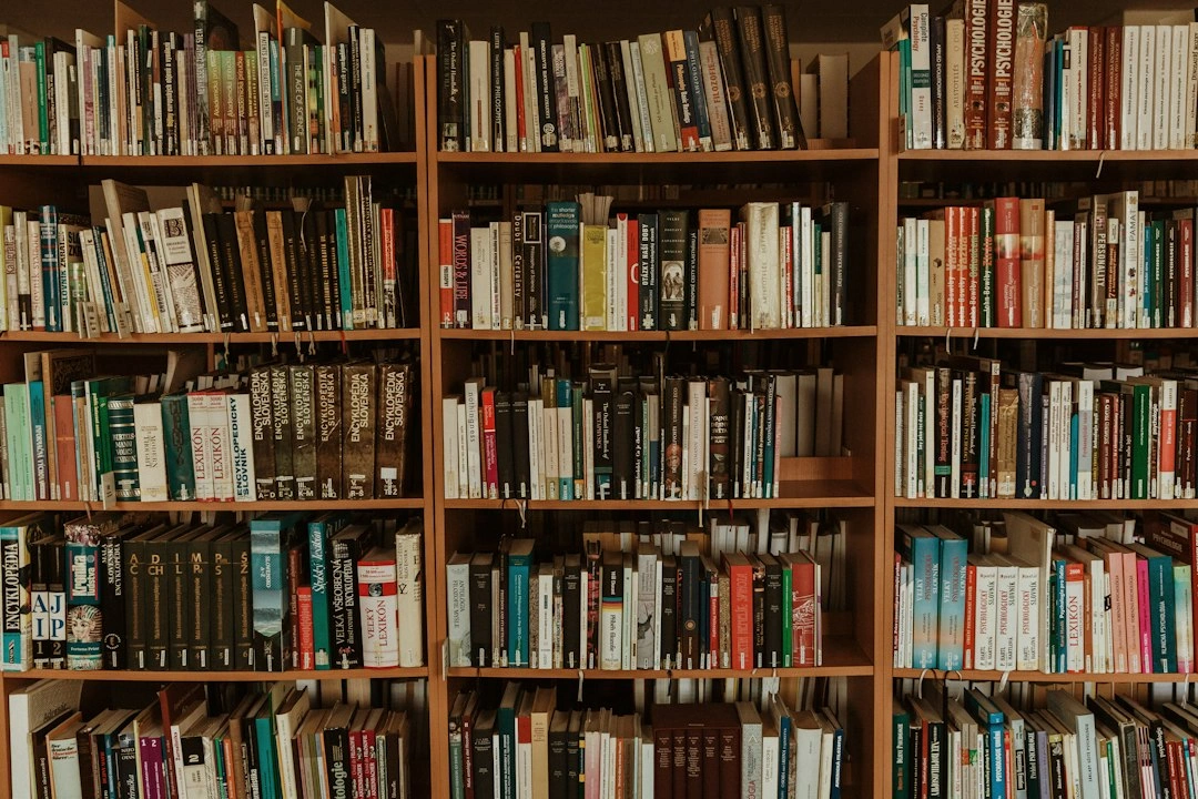 Warmly lit rows of books on shelves