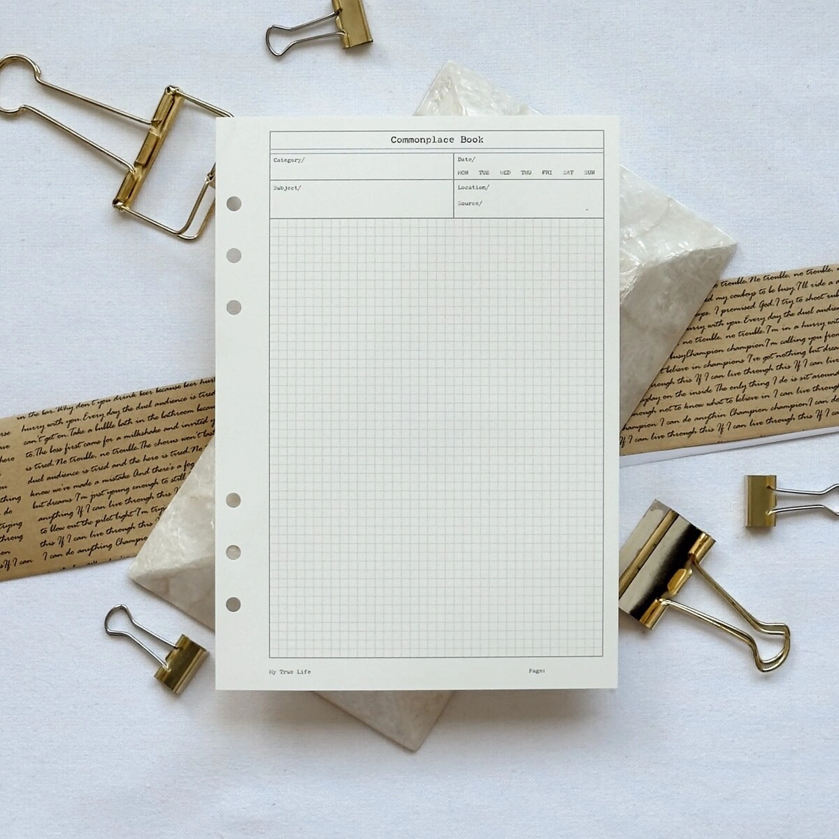 Commonplace Book ring binder insert surrounded by gold binder clips